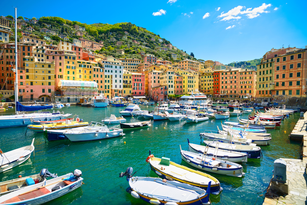 Camogli marina harbor, boats and typical colorful houses. Travel destination Liguria, Italy, Europe.