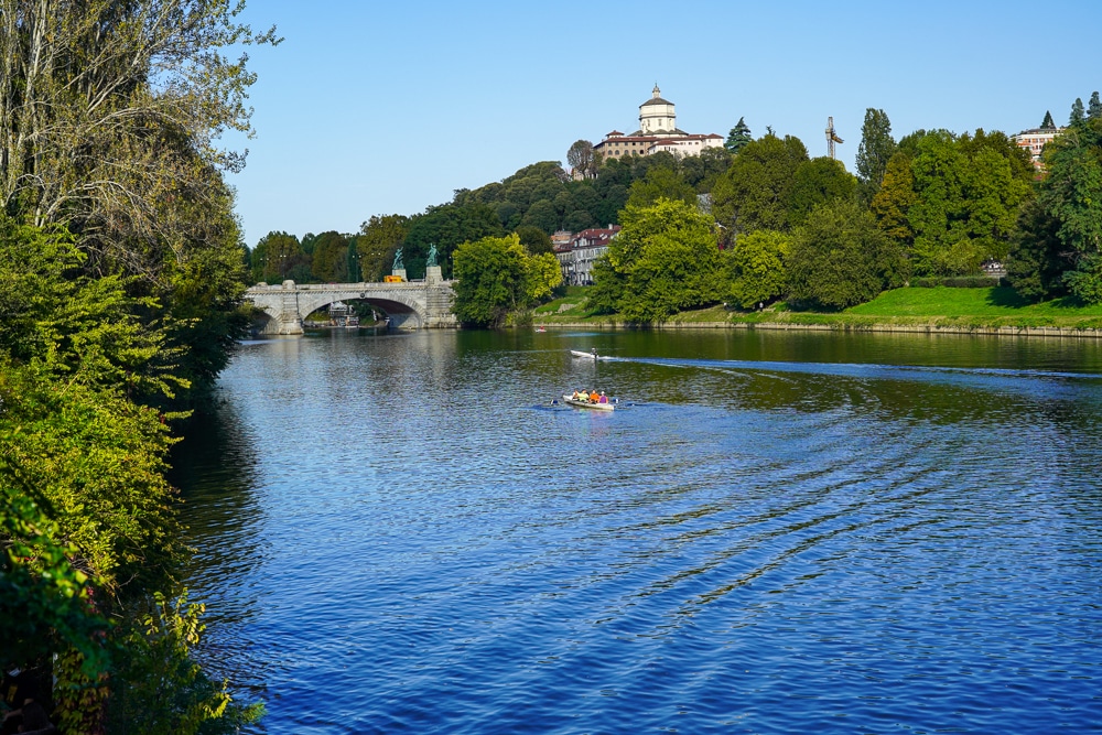 Po River view with rowers and Valentino Park in Turin Italy