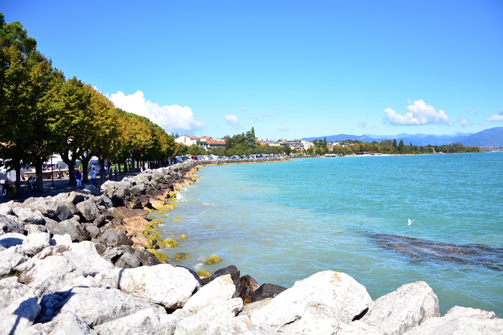 rocky shore of Lake Garda with turquoise water in Desenzano del Garda Italy