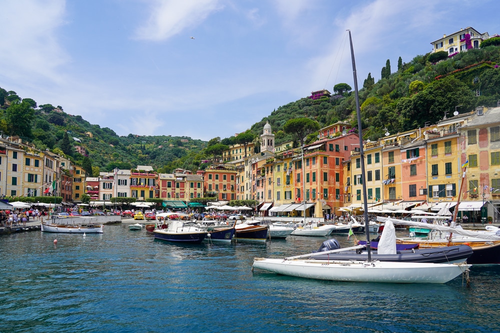 portofino Liguria harbor with colorful houses in the background and boats in the foreground