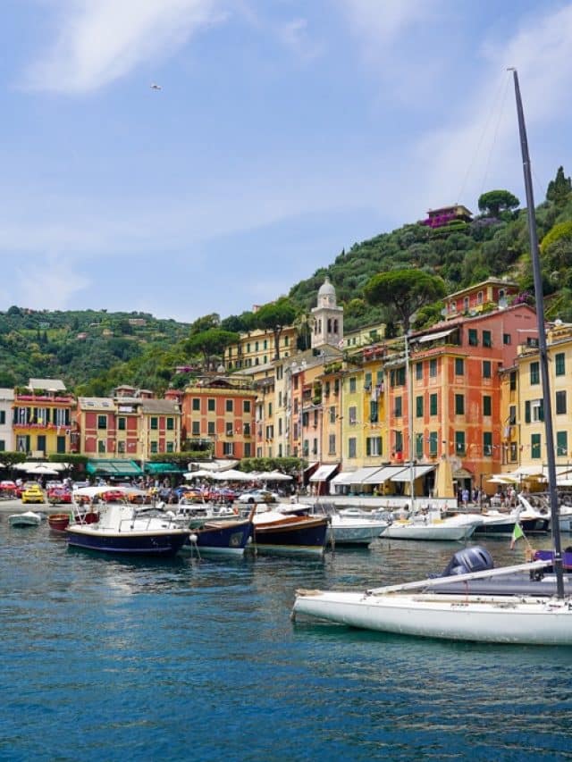 portofino Liguria harbor with colorful houses in the background and boats in the foreground
