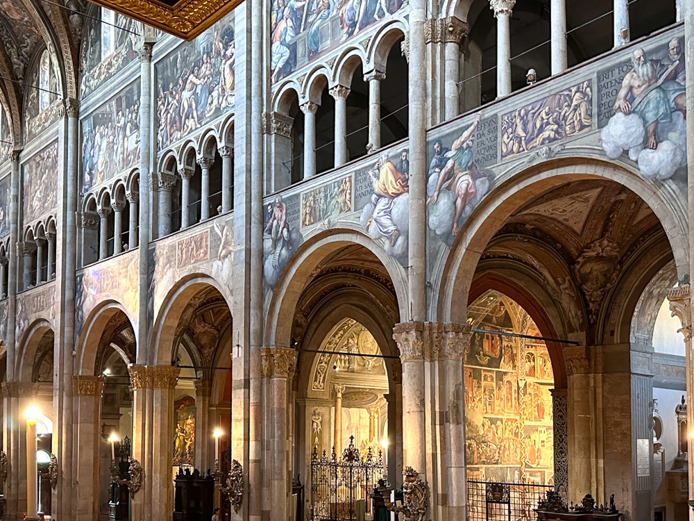 Parma Cathedral in Emilia Romagna Italy - interior side view of frescoes and arches
