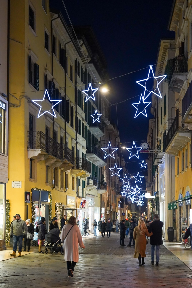 Christmas light stars haning over a street in the old town in Verona at Christmas