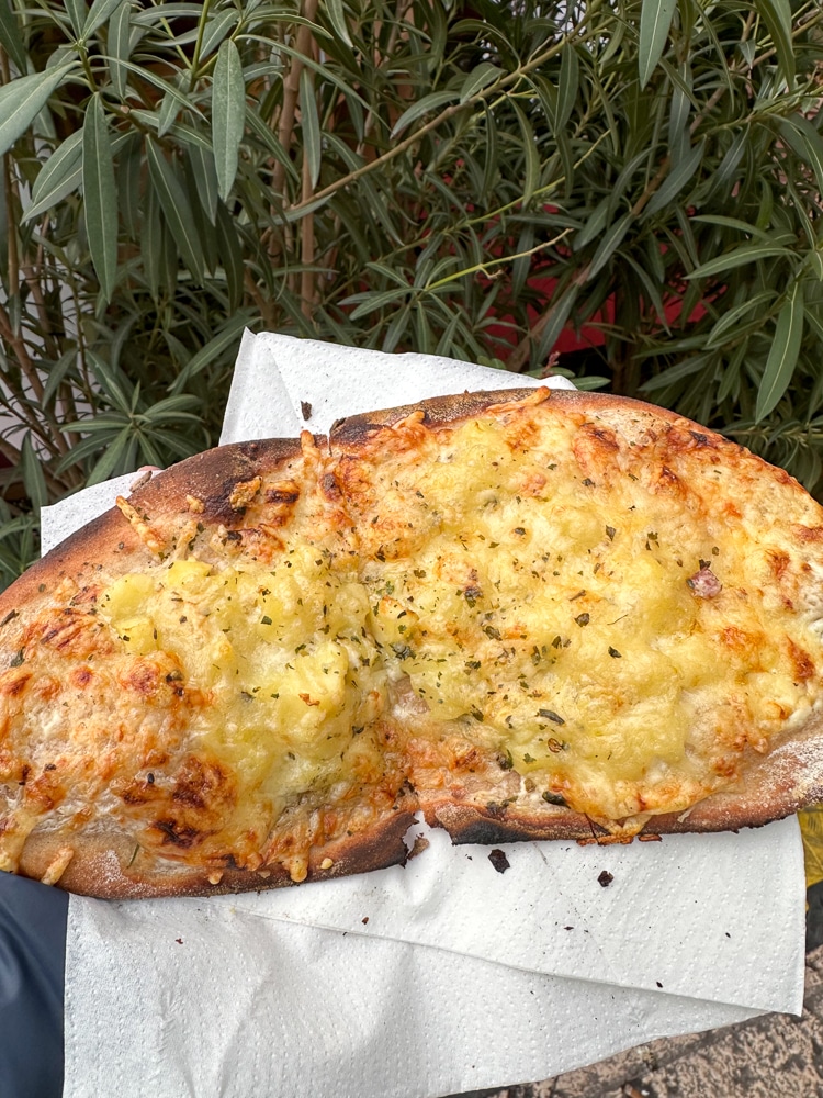 flatbread pizza with potatoes and cheese at a Christmas market in Verona Veneto italy