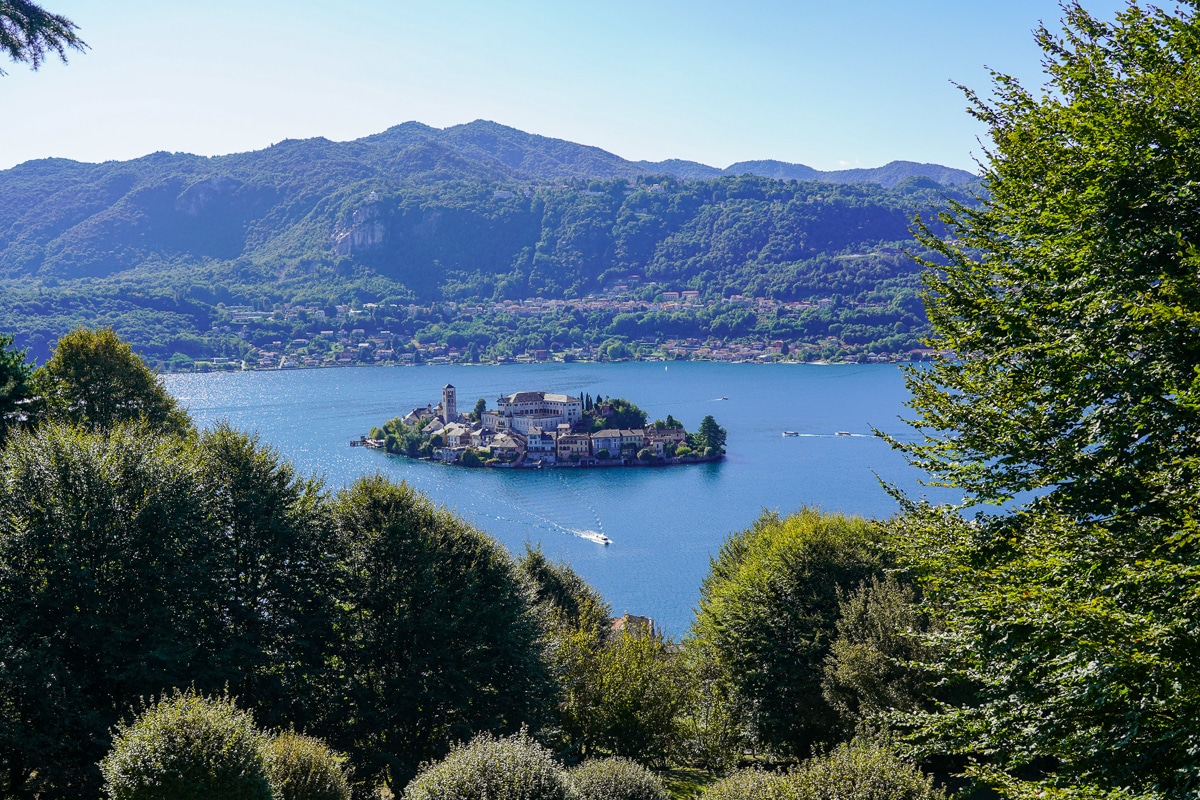 birds eye view through trees of the island of san giulio on Lake Orta in Italy