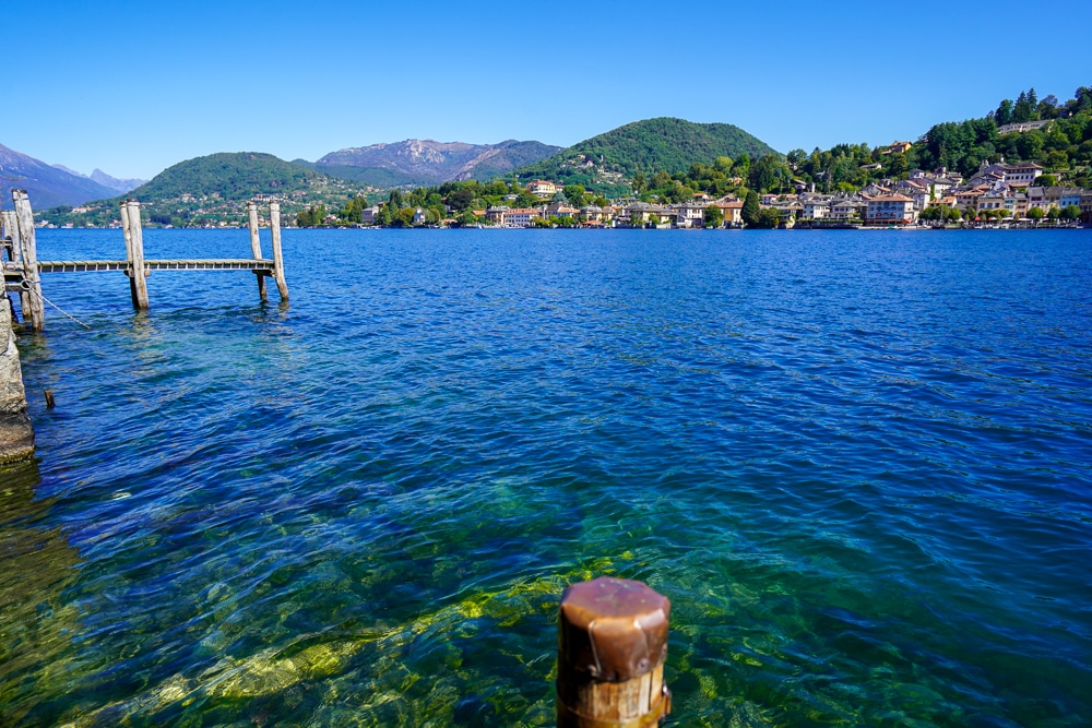 crystal clear lake with mountains in the background