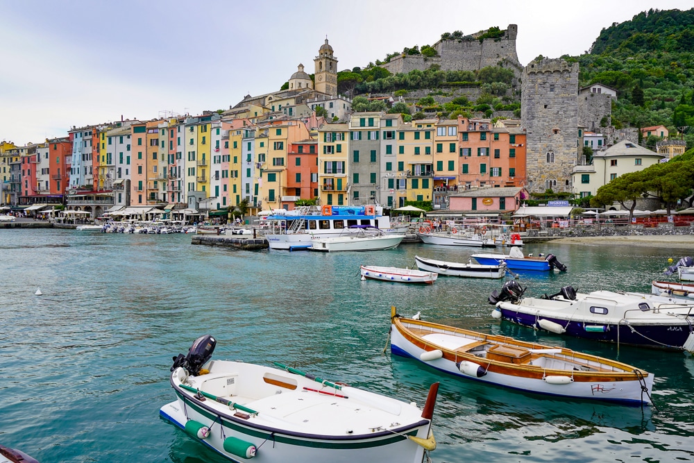 Portovenere Italy harbor - colorful houses in front of the sea with small boats in the foreground