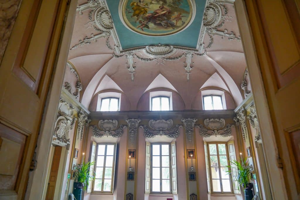 walking into a luxurious pink room with ornate ceiling designs at Isola bella Lake Maggiore