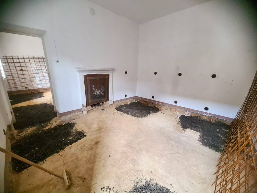 room in an old italy house with the floor dug out and filled in moisture barriers