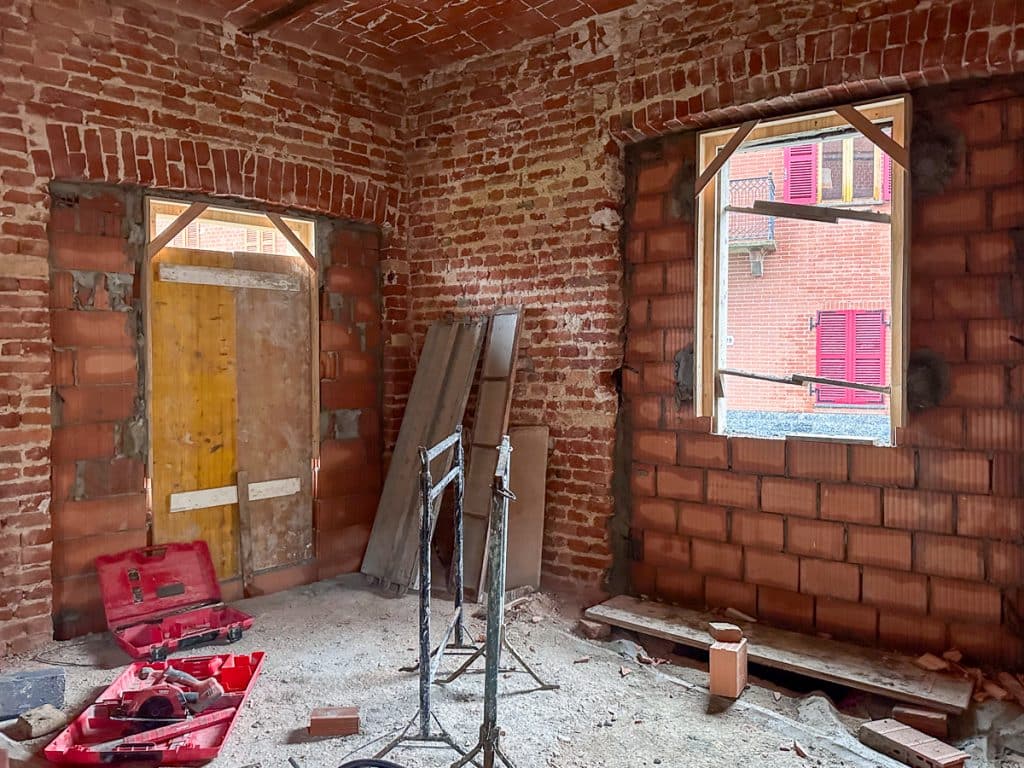 house in italy with new bricks making window openings after changing doors to windows