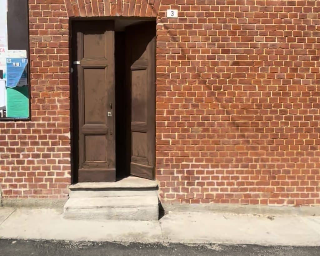 old front door on an old brick house in Italy