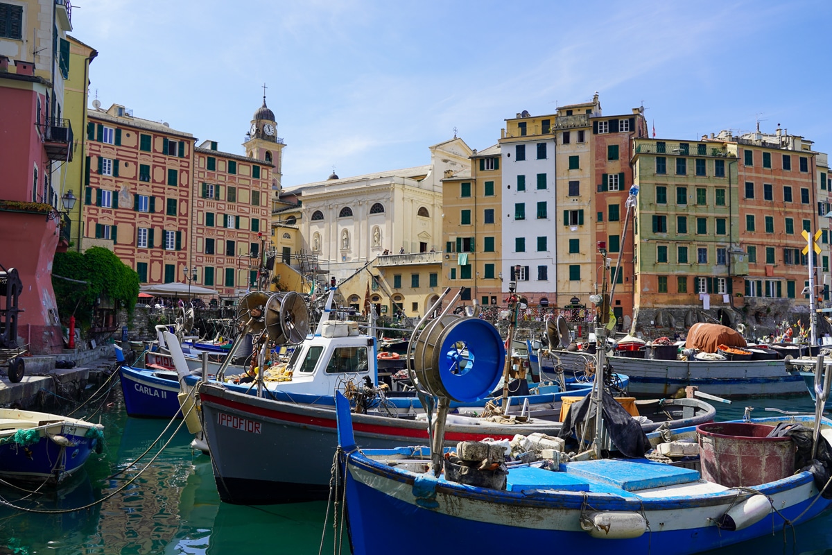 harbor in Camogli with fishing boats in the foreground and colorful buildings in the background
