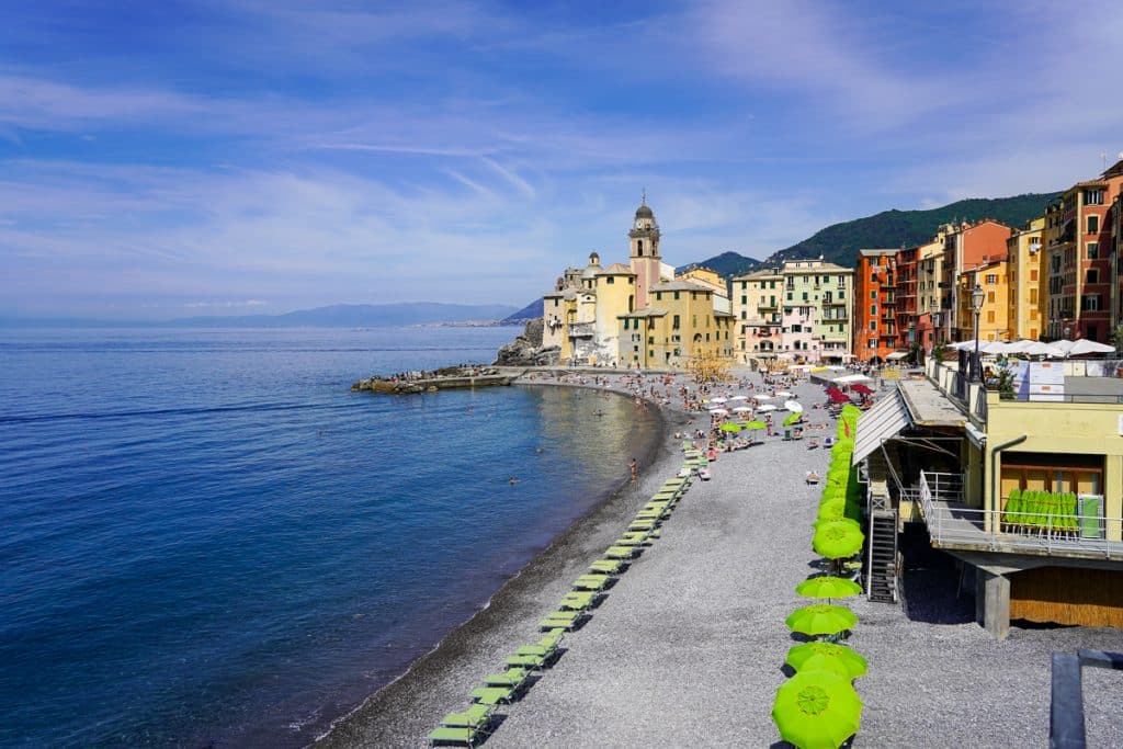 the beach in camogli almost empty except for a few beach umbrellas