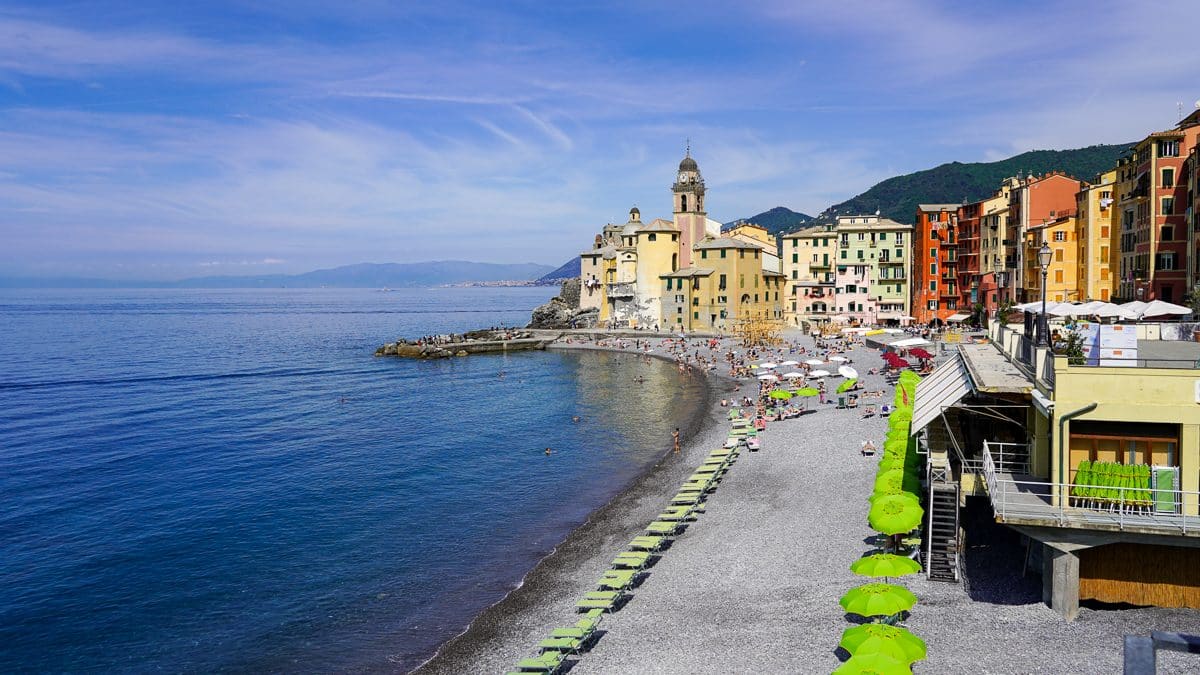 the beach in camogli almost empty except for a few beach umbrellas