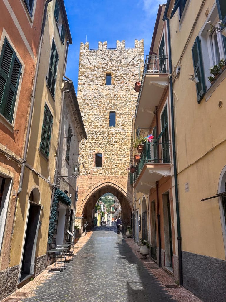medieval old town of Noli with a stone tower at the end of the alley