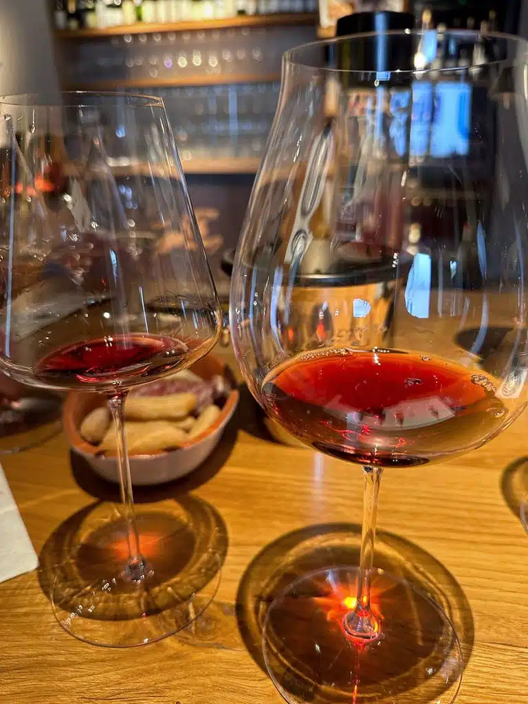 2 wine glasses with sips of red wine in them at a wine tasting in Monferrato Italy